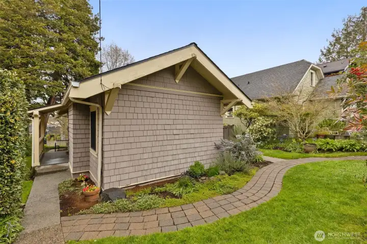 Door with covered porch leads from the kitchen to the south-facing backyard, garage and parking. Mature landcaping makes this home beautiful all year round.