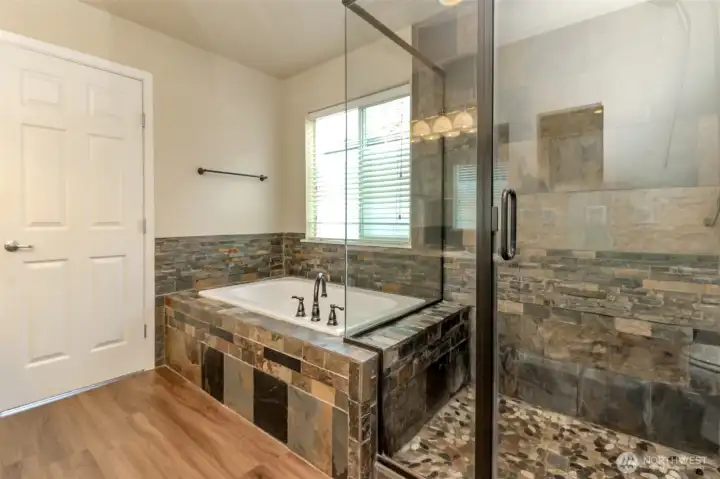 Primary soaking tub and walk-in tiled shower