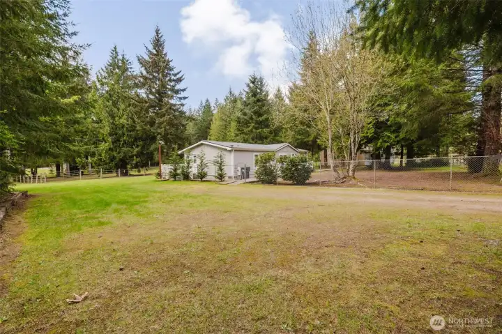 Ample parking, garage/SHOP in background to the right of the home. Pasture behind home.