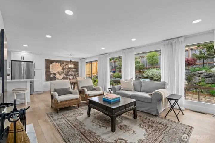 Walls of windows, a wood-burning fireplace, and natural light from every angle. This room draws you in immediately.
