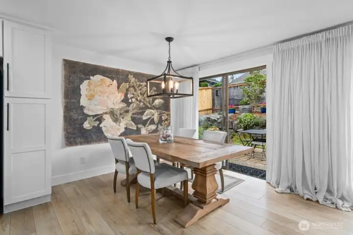 The dining area opens directly to the patio through a sliding glass door. Indoor and outdoor living at its best.