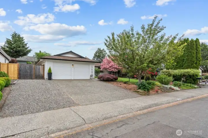 The oversized driveway with third parking space and beautifully maintained landscaping make a lasting first impression.