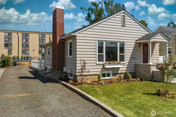 Long parking strip beside house leads to alley