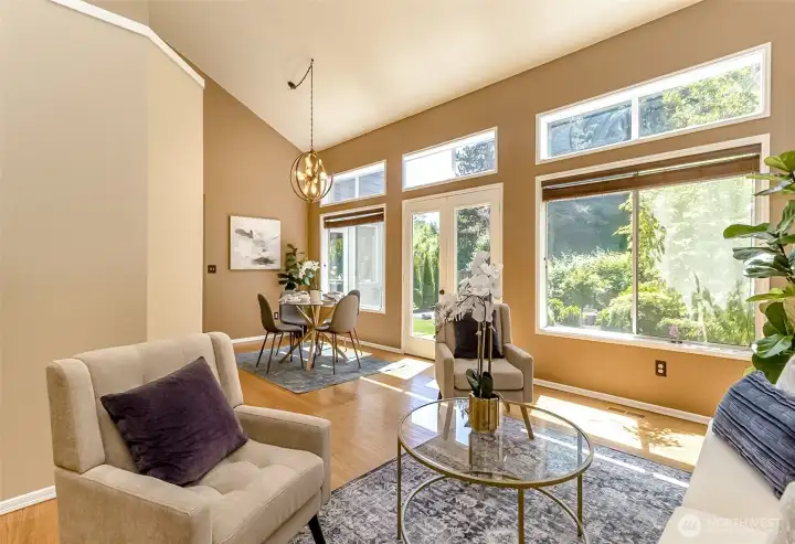 Relax here.....the Living Room and Formal Dining rooms are flooded with natural light from the cathedral ceilings and the wall of windows.
