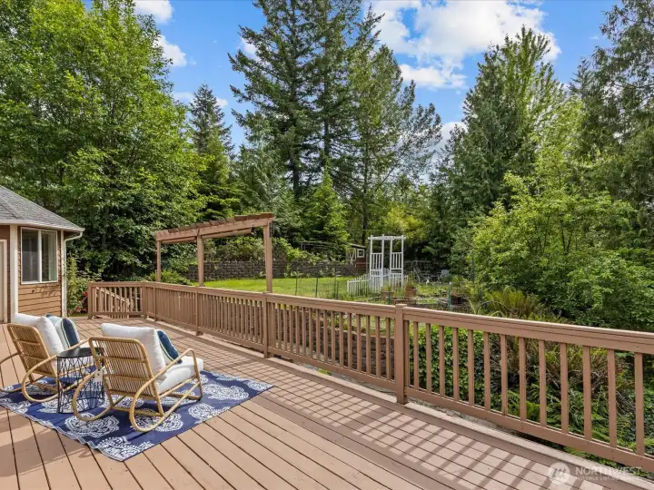 Enjoy the freshly updated, -new entertainment-sized deck off both the kitchen and primary suite—perfect for morning coffee, outdoor dining, and taking in the beautiful garden views.