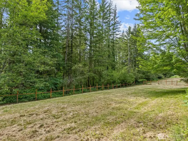 Newer fencing surrounds the property, providing added privacy, security, and a beautiful finishing touch to the outdoor spaces.