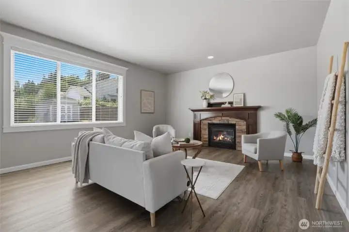 The great room includes a natural gas fireplace and big window to the back yard.