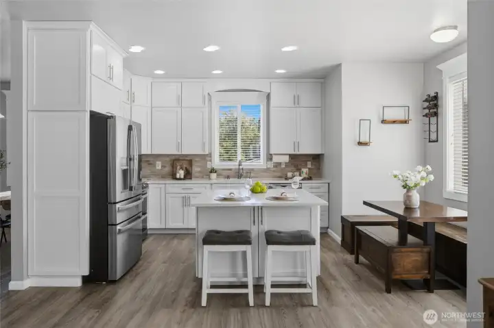 Kitchen and breakfast nook. Counter stools and table/benches will remain in the home if the buyer desires.