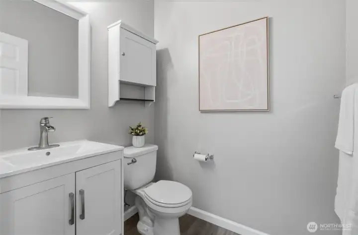 A sparkling powder room is off the great room and across the hall from the laundry.