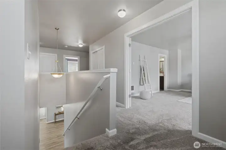 Landing in the upper level with double doors opening to the spacious primary bedroom/bathroom suite.