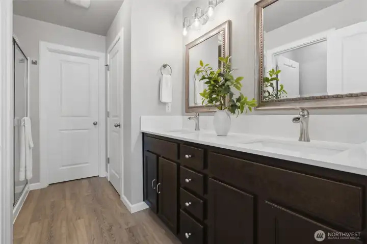 Primary bathroom off the primary bedroom. The doors open to linen and clothes closets.