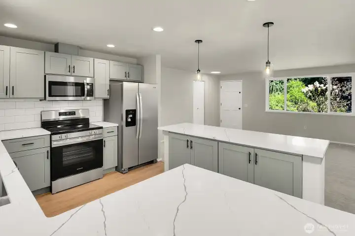 Chefs kitchen boasts Quartz countertops, center island, lots of cabinets and light and open Chefs kitchen boasts Quartz countertops, center island, lots of cabinets and light and open