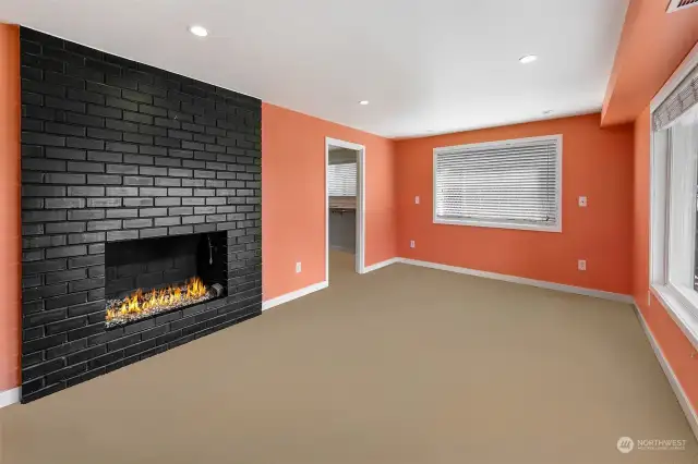 Primary bedroom with gas fireplace and large walk-in closet.