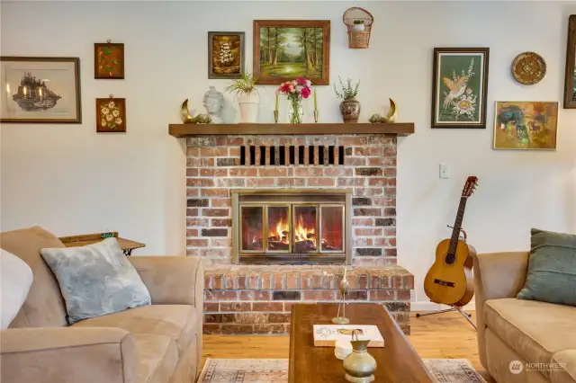 Now that we've had a bit of a preview, take a closer look at the living room with its wood-burning fireplace and brick hearth.