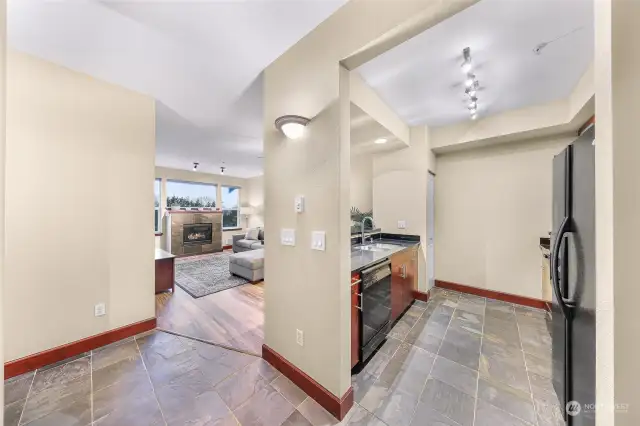 This unit is located on the top floor (4th floor). As you enter in the front door, you are greeted with slate floors and an open kitchen to your right.