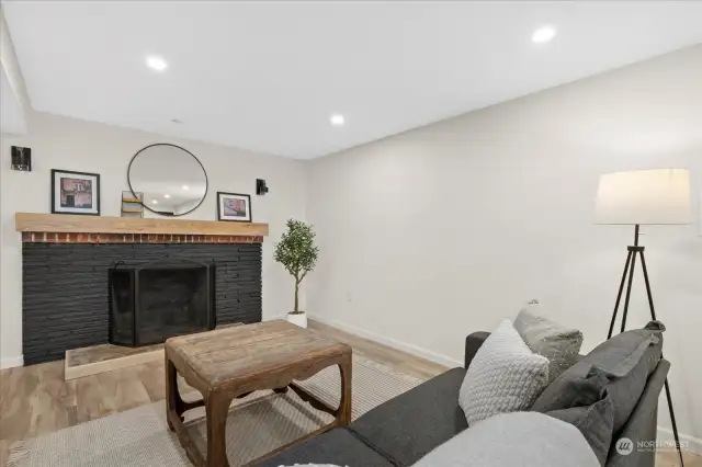 Sitting area downstairs provides a serene setting with freshly painted fireplace.