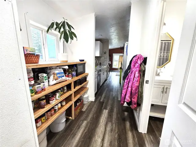 Organized shoe racks in pass through from back door & laundry