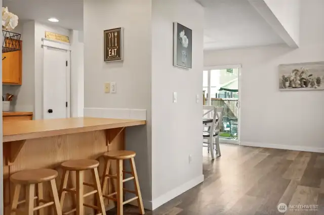Living room open to kitchen via breakfast bar