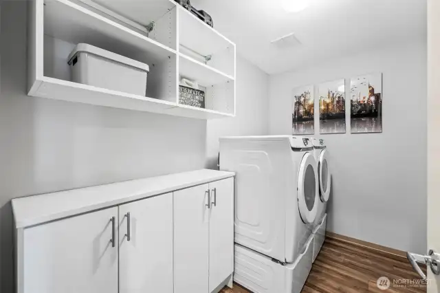 Laundry with New Samsung Front-loaders and convenient storage cabinetry.