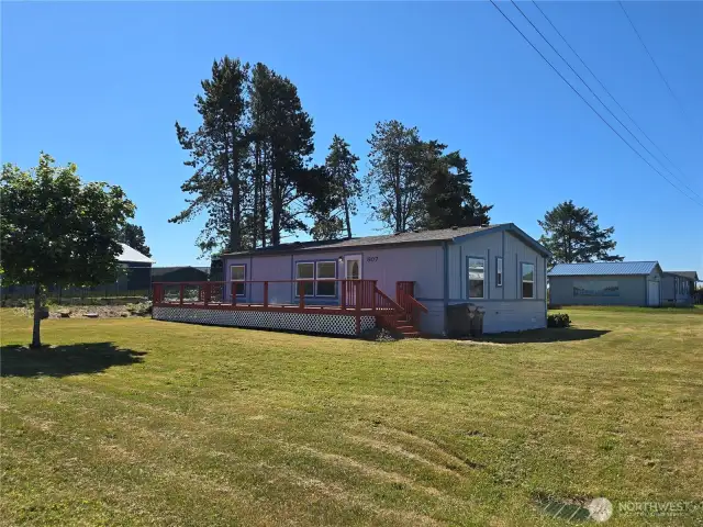 Front of home with large wrap around deck