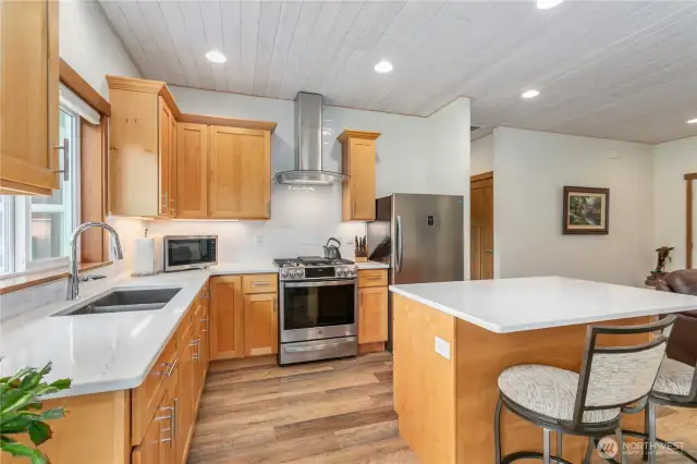 Spacious walk-in pantry (door is just to the right of the fridge) offers ample shelving and storage to keep everything organized and within easy reach.