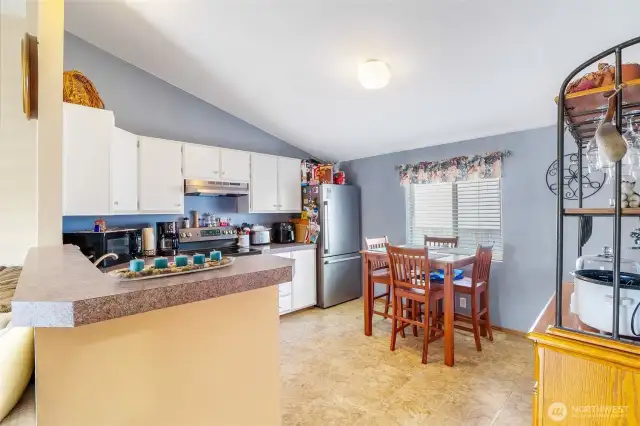 Here we have a well-lit kitchen area with room for a table to enjoy a meal with your loved ones.
