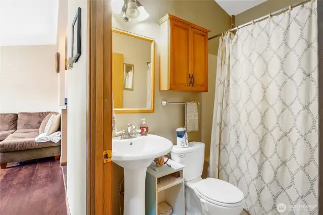 The main bathroom is in the hallway, which includes a tub and shower.