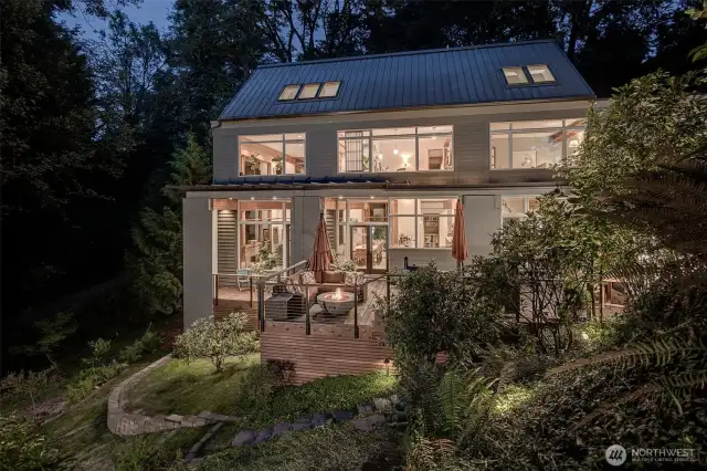 Custom Jim Cutler-designed home in sylvan west-facing setting with 37 feet of private waterfront.