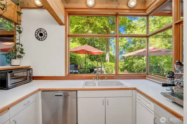 Kitchen includes a separate prep area with ovens, sink, and dishwasher.
