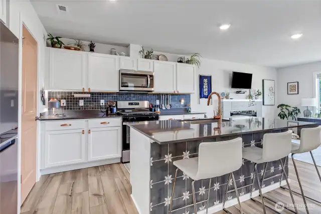 Tile back splash and toe kick on island wall add a touch of flare.