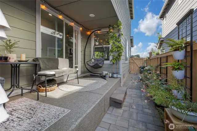 Side yard is compact but very versatile. Pavers and pea gravel make it low maintenance
