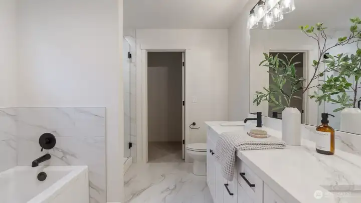 Spa like Primary Bathroom has tile flooring and beautifully tiled shower.