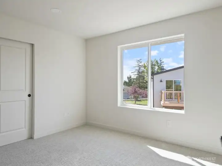 One of 4 bedrooms with upgraded carpet and pad.