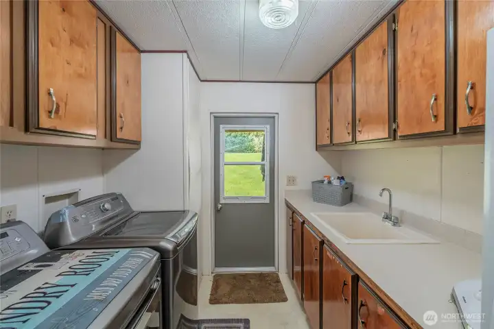 Laundry room with sink and storage