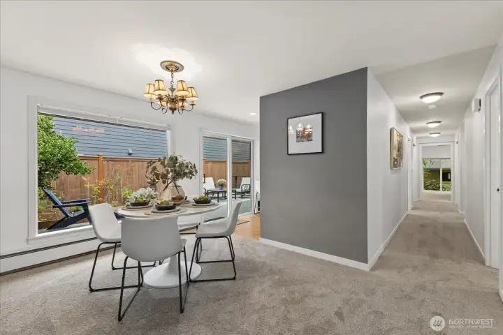 Effortlessly flow into the dining room which is conveniently located right off the kitchen. Sliding door gives easy access to the sun-drenched deck.