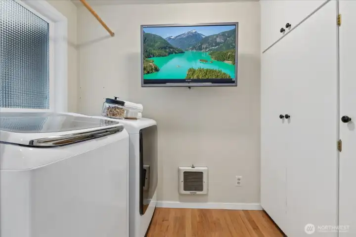 Main floor laundry room features a wall of pantry cupboards - perfect for all of your dry storage needs.