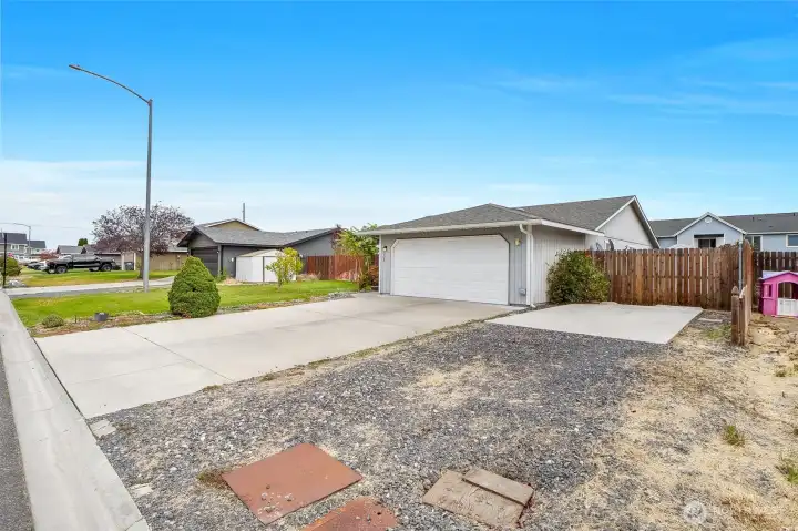 Right next to the garage is gravel and a concrete pad to park your RV.