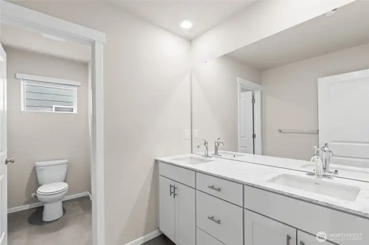 double sinks with a door on the water closet