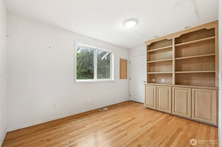 Office on main floor with closet and built in shelving