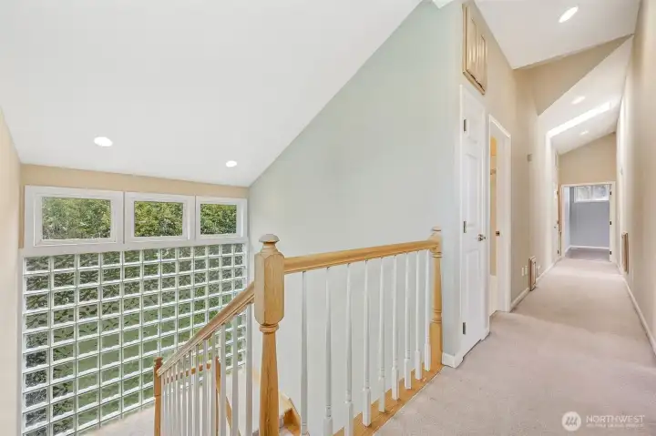 Stairwell to upstairs with 2 bedrooms plus primary with ensuite