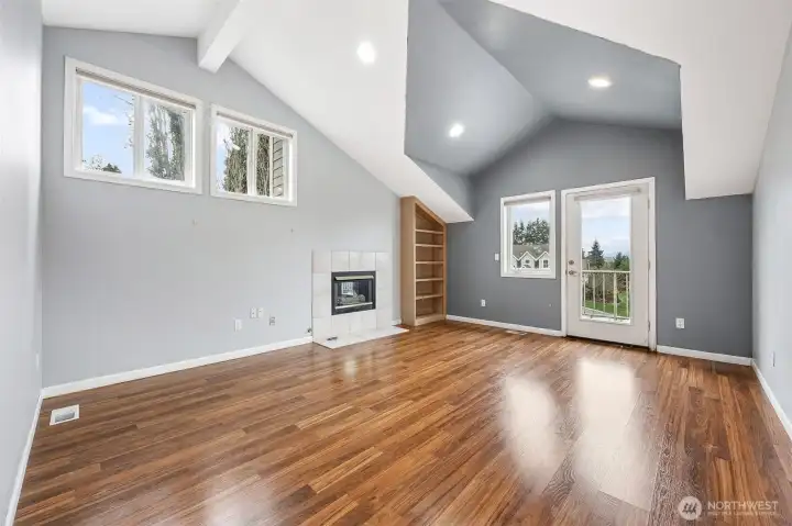 Primary bedroom with gas fireplace and exterior door to top deck. Views of Mt Rainier