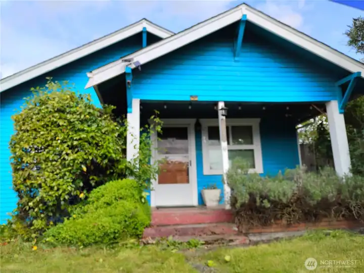 Curb appeal with the large covered porch and mature landscaping