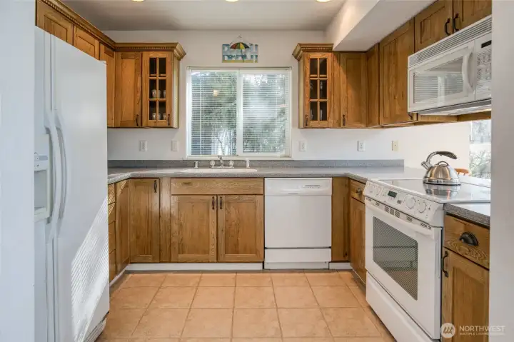 Kitchen has lots of counter space, flat top stove