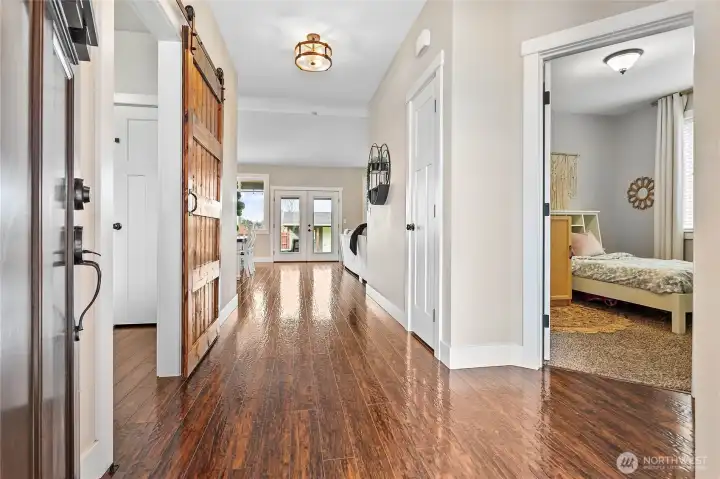 Inviting foyer w/extra wide hallway. 2 bedrooms & full bathroom to right, 3rd bedroom (or office/den) to left