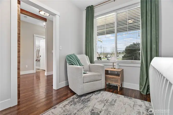 4th bedroom (could be office/den) w/large window, closet wood flooring & barn door