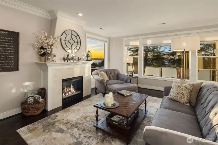The family room feels like a warm hug with its rich wood floors and cozy gas fireplace