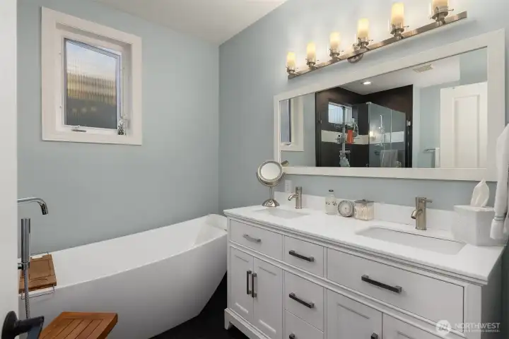 Ensuite bath includes a double vanity and freestanding soaking tub