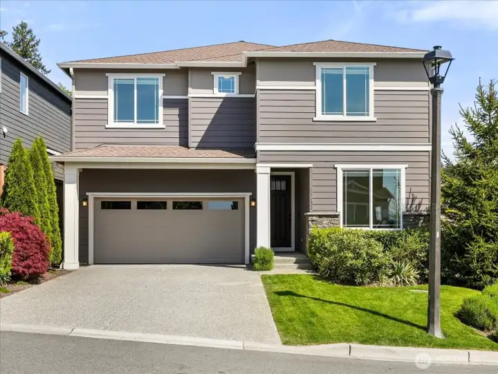 A stunning first impression with timeless architecture and elegant curb appeal.