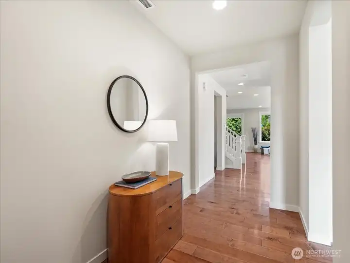Elegant engineered hardwood flooring sets the tone throughout the home.