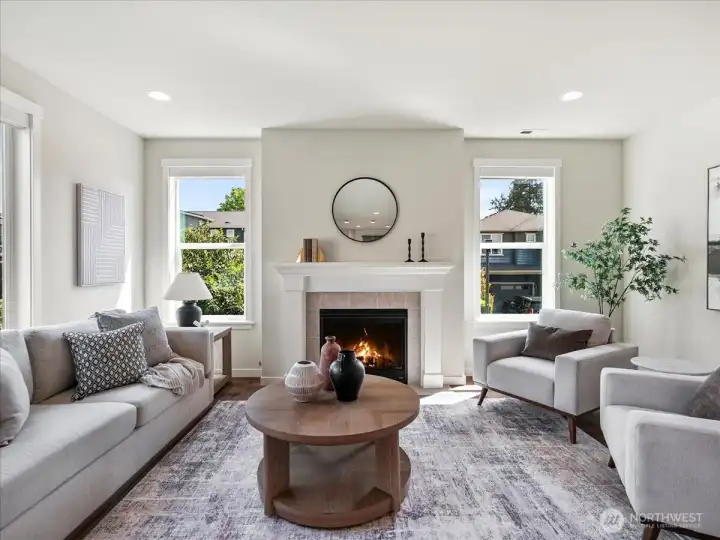 Cozy fireplace anchors this light-filled living space with warmth and charm.
